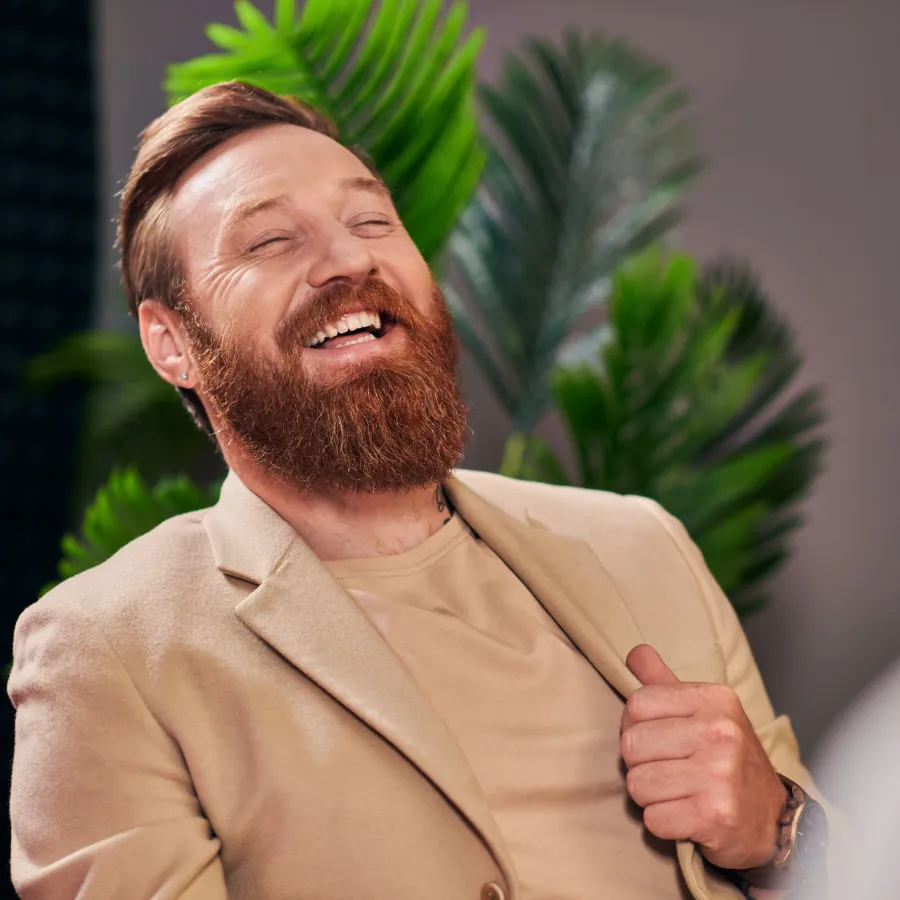 A business owner laughing in their workplace